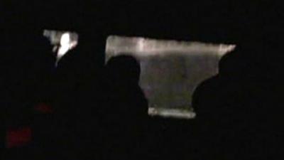 Silhouettes of passengers in lifeboat