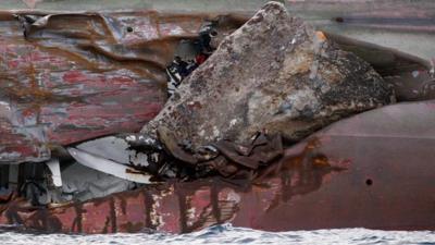 Rock protrudes from large gash in the hull of the capsized Costa Concordia cruise liner