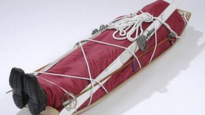 A coffin complete with skis