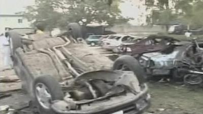 Burnt and overturned cars which were hit by a bomb attack