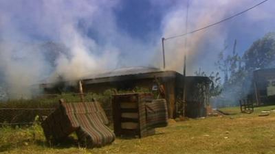 Kenyan home on fire in post election violence in 2007