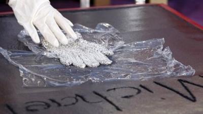 Paris Jackson places a glove worn by her father, Michael Jackson, into the cement during the hand and footprint ceremony.