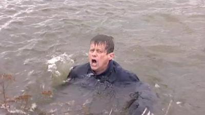 Mike Bushell pulls a face while splashing to get out of cold water.