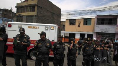 Police officers stand guard outside the rehabilitation centre in Lima