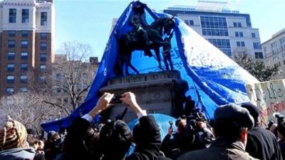 Statue of General McPherson covered by a tarpaulin