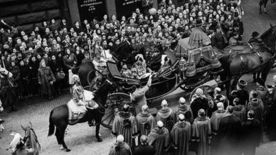 Crowds watch a parade to celebrate the proclamation of Queen Elizabeth II's accession to the throne, Feb 1952