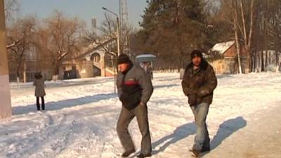 People walking through snow in Ukraine