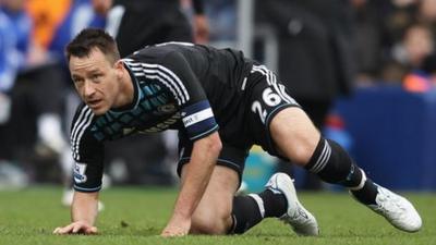 John Terry kneeling on grass