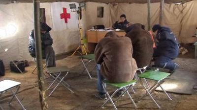 People in heated tent in Ukraine