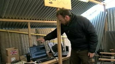 BBC Scotland reporter Cameron Buttle shows broadcast equipment in an army base in Afghanistan