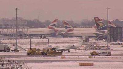 Planes at a snowy Heathrow