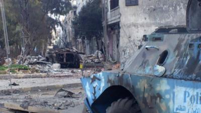 Burnt-out tank in Homs
