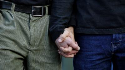 A gay couple holding hands