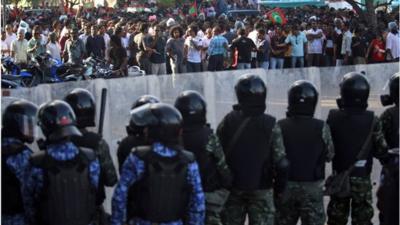 Riot police and protesters in Male