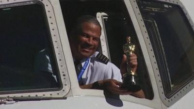 A pilot with an Oscar statuette