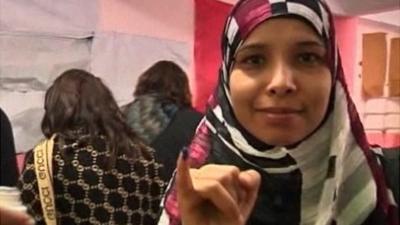 Egyptian woman showing the ink on her finger indicating casting her vote