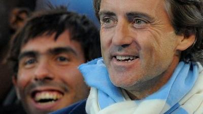 Manchester City's Carlos Tevez with Roberto Mancini