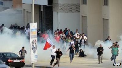 23 January - Bahrain protesters run away from tear gas in Zinj village