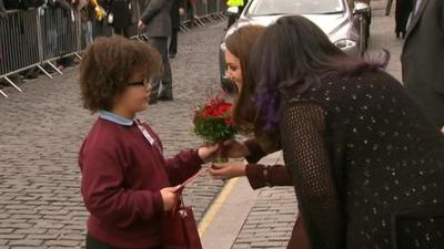 The Duchess of Cambridge receives flowers from a child