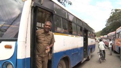 A conductor on a bus in India