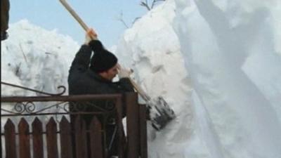 Man digs through snow