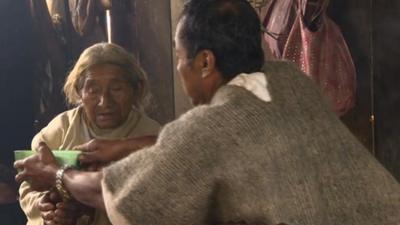 Traditional Mayan healer working with patient