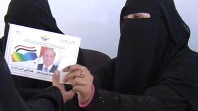 Voting card being handed over at polling station