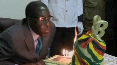 President Robert Mugabe blows out birthday candles