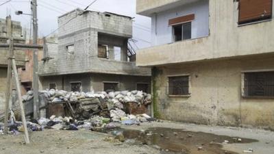 Damaged houses in Karm Al Zaytoon, a neighbourhood of Homs.