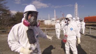 Roland Buerk in protective suit inside Fukushima plant