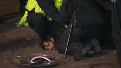 An Occupy protester being held by police