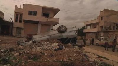 Upturned car in the northern Syrian town of Sarmin