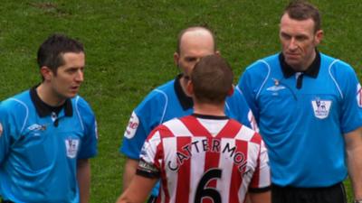 Sunderland captain Lee Cattermole and referee Mike Dean