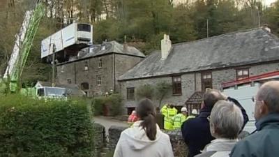 Lorry being winched out of narrow road in Cornwall