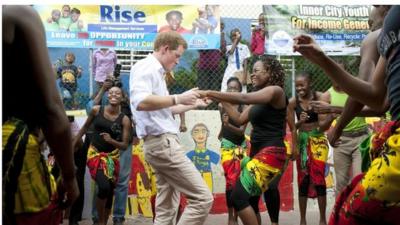 Prince Harry dances with Chantol Dorner during a visit to the Rise Life charity project in Jamaica