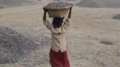 A child carries rocks