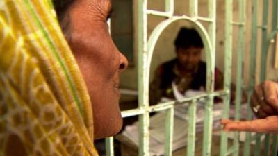 A woman waits for help at a project paid for by British aid money