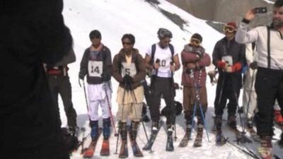 Skiers line up on the slopes of Bamiyan