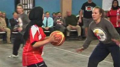 Afghan women playing basketball with a team from the International Security Assistance Force and the US embassy