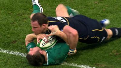 Tommy Bowe is tackled by Graeme Morrison