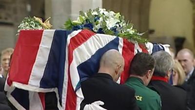 Pall bearers carry PC David Rathband's coffin