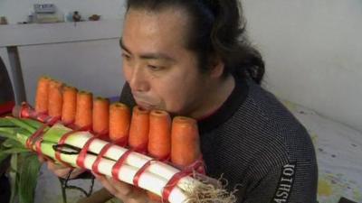 A musician with an instrument made from carrots