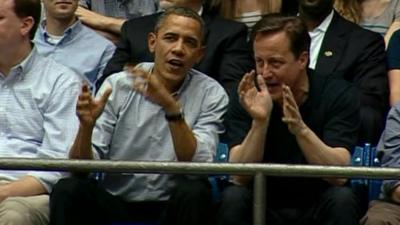 Barak Obama and David Cameron watch basketball game in Ohio.