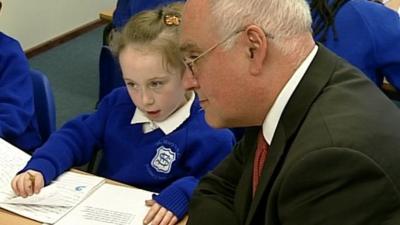 Sir Michael Wilshaw with child