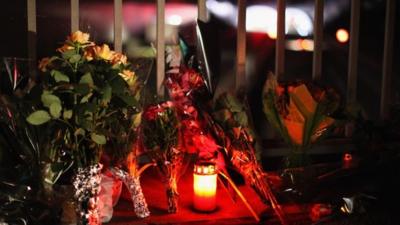 Flowers and candles near the scene