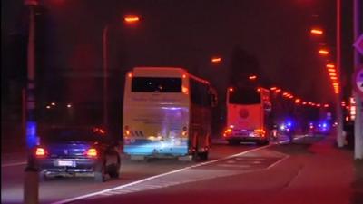 Convoy of coaches carries crash survivors home to Belgium.