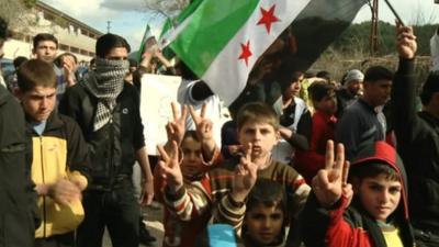 Refugees from Syria in Turkey make victory signs.