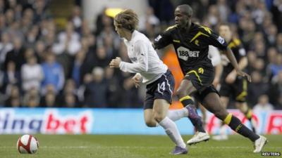 Tottenham's Luka Modric runs with the ball next to Bolton Wanderers' Fabrice Muamba