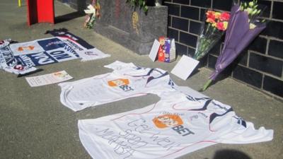 Shirts bearing get well messages outside the Reebok Stadium in Bolton