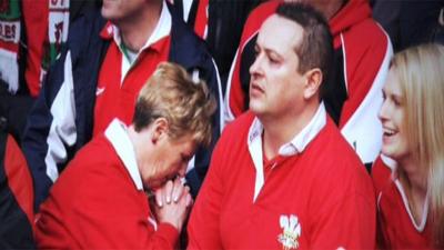 A fan prays as Wales bid for the Slam against France